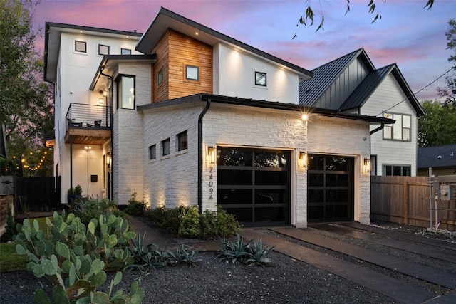 view of front facade with a garage and a balcony