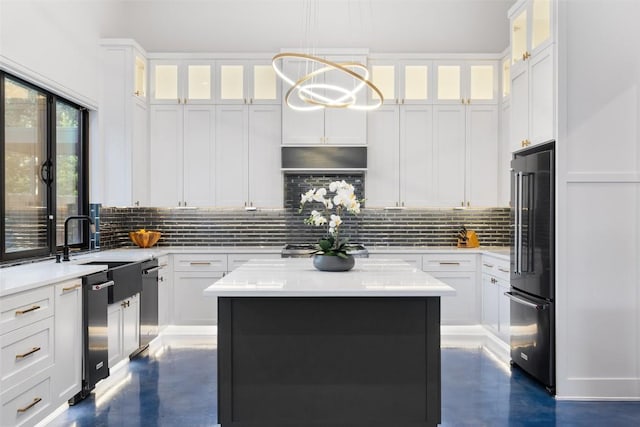 kitchen with a center island, decorative backsplash, white cabinets, decorative light fixtures, and high end refrigerator