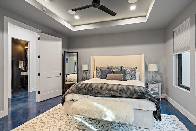 bedroom with a tray ceiling, dark hardwood / wood-style floors, and ceiling fan