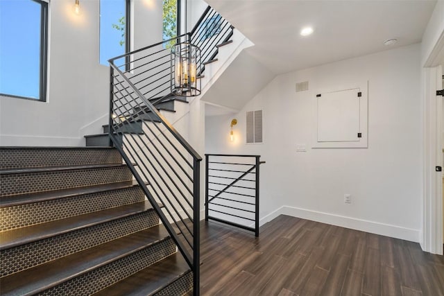 stairs featuring wood-type flooring