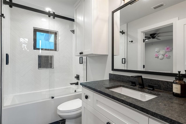 full bathroom featuring toilet, ceiling fan, vanity, and shower / bath combination with glass door