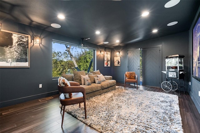 home theater room featuring dark hardwood / wood-style flooring