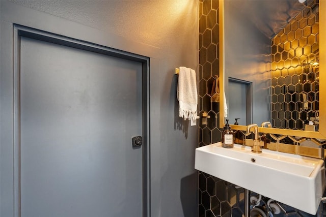 bathroom with sink, tile walls, and decorative backsplash