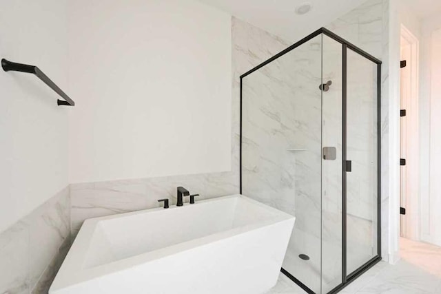 586 Biscayne Bay Bnd, Kyle, TX 78640 - full bathroom featuring a soaking tub, marble finish flooring, a marble finish shower, and tile walls