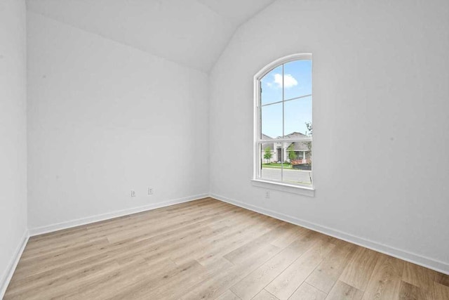 586 Biscayne Bay Bnd, Kyle, TX 78640 - spare room featuring vaulted ceiling and light wood-type flooring