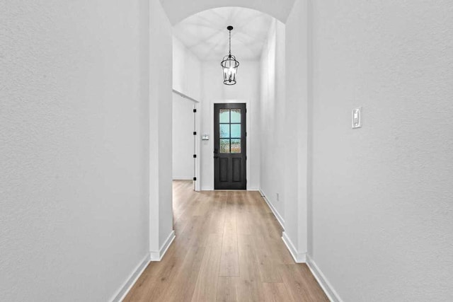 586 Biscayne Bay Bnd, Kyle, TX 78640 - entryway with arched walkways, light wood finished floors, and a textured wall