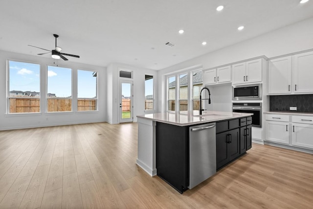 586 Biscayne Bay Bnd, Kyle, TX 78640 - kitchen featuring appliances with stainless steel finishes, open floor plan, recessed lighting, white cabinets, and plenty of natural light