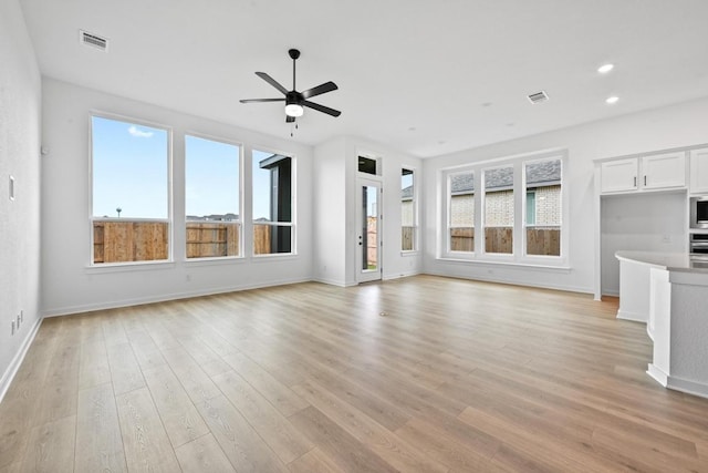 586 Biscayne Bay Bnd, Kyle, TX 78640 - unfurnished living room featuring plenty of natural light, ceiling fan, light wood-style floors, and recessed lighting