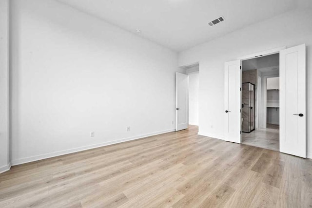 586 Biscayne Bay Bnd, Kyle, TX 78640 - unfurnished bedroom featuring light wood-type flooring and baseboards