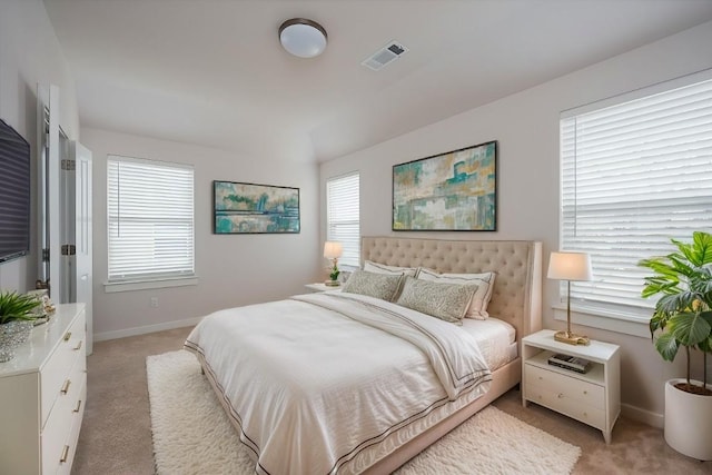 bedroom with light carpet, visible vents, and baseboards