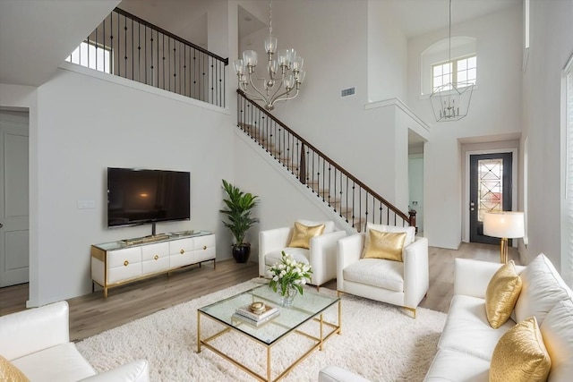 living room featuring wood-type flooring and a notable chandelier