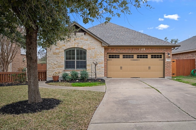 view of front of property featuring a garage and a front yard