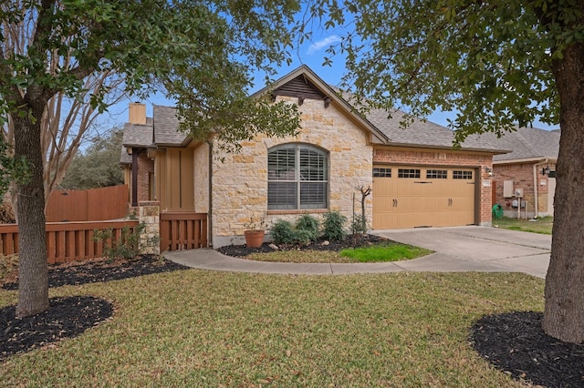 view of front of house featuring a garage and a front lawn