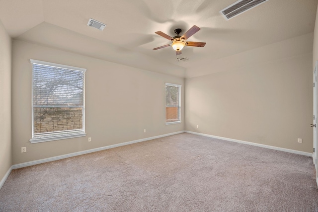 carpeted empty room with vaulted ceiling and ceiling fan