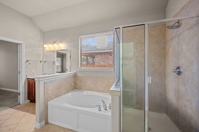 bathroom featuring plus walk in shower, lofted ceiling, tile patterned floors, and vanity