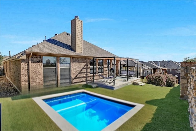 back of house featuring a patio area and a lawn