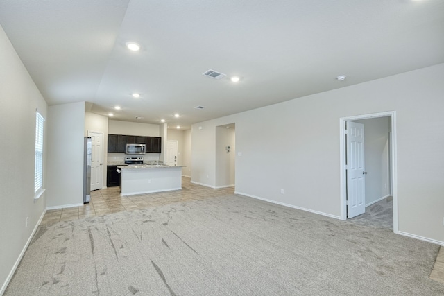 unfurnished living room with light colored carpet