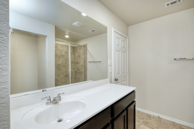 bathroom with vanity, tile patterned floors, and a shower with shower door