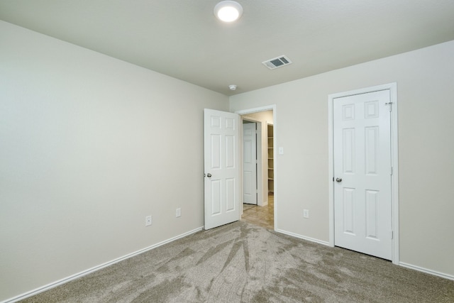 unfurnished bedroom with light carpet