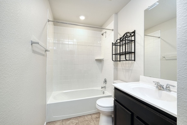 full bathroom featuring vanity, toilet, tiled shower / bath combo, and tile patterned flooring