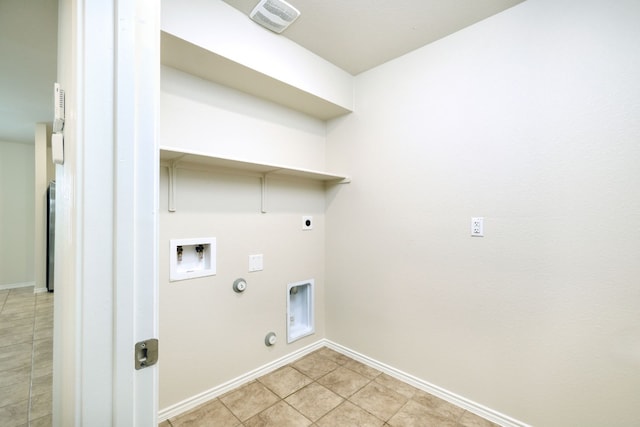 washroom featuring gas dryer hookup, washer hookup, light tile patterned floors, and electric dryer hookup