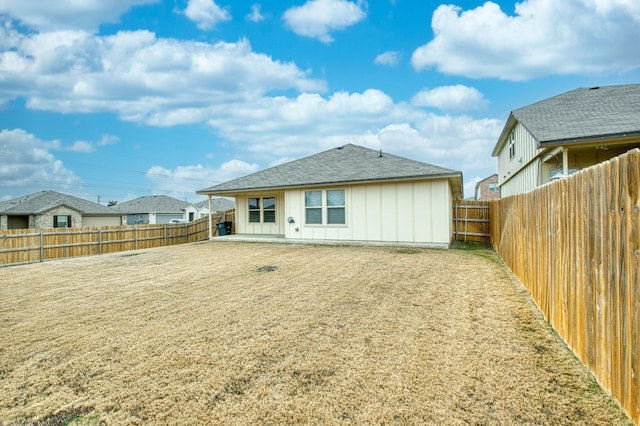 back of house with a lawn