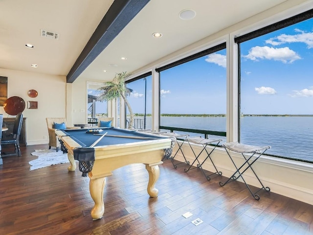 rec room featuring a water view, billiards, dark hardwood / wood-style floors, and beamed ceiling