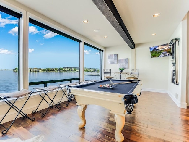 recreation room featuring beam ceiling, a water view, pool table, and light wood-type flooring