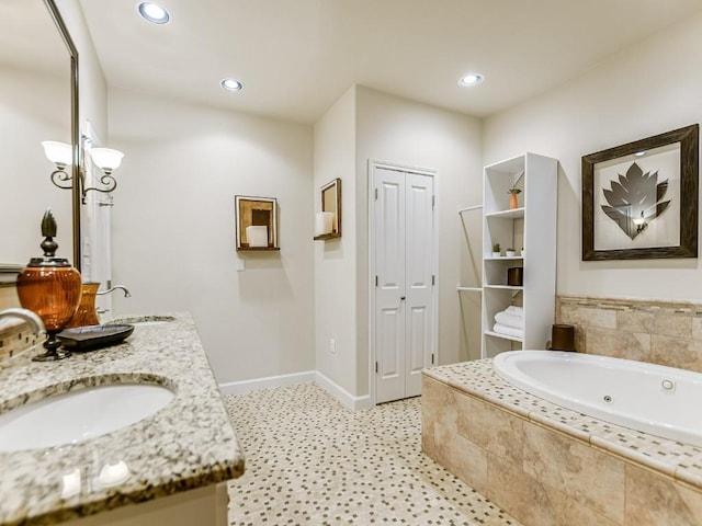 bathroom featuring vanity and a relaxing tiled tub