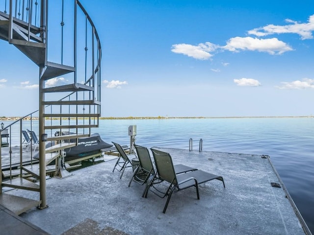 view of patio / terrace featuring a dock and a water view