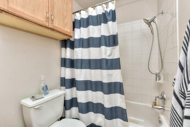 bathroom featuring shower / tub combo and toilet