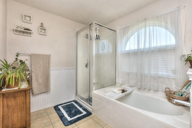 bathroom with separate shower and tub and tile patterned floors