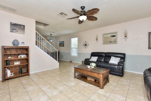 tiled living room with ceiling fan