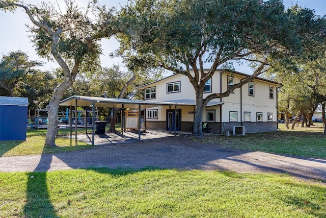 view of front of property with cooling unit and a front lawn