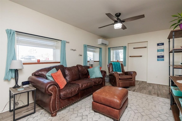 living room featuring ceiling fan, wood-type flooring, and a wall mounted AC