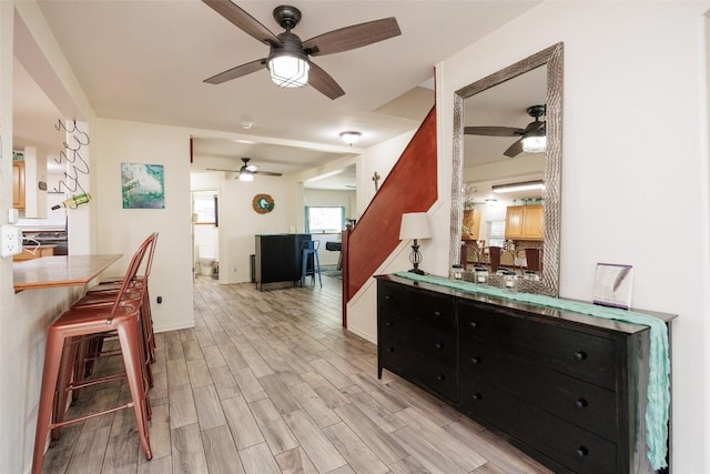 kitchen featuring tile counters, a breakfast bar, and light wood-type flooring