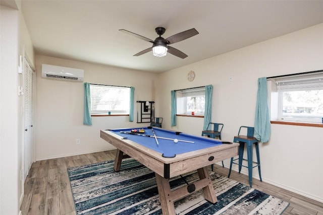 rec room with hardwood / wood-style flooring, pool table, ceiling fan, and an AC wall unit