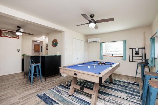 playroom featuring billiards, a wall mounted air conditioner, ceiling fan, and light hardwood / wood-style flooring