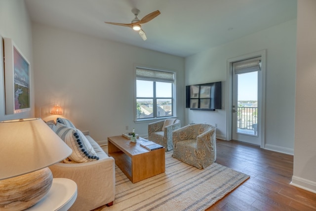 living room with hardwood / wood-style flooring, ceiling fan, and a healthy amount of sunlight