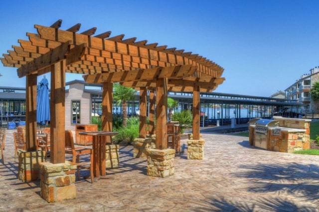 view of patio / terrace featuring area for grilling, grilling area, and a pergola