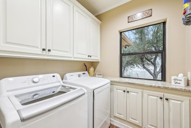 laundry area featuring separate washer and dryer and cabinet space