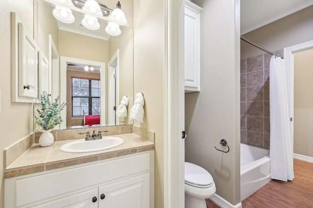 bathroom featuring toilet, wood finished floors, vanity, and shower / tub combo