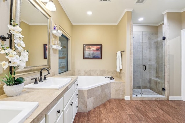 bathroom with vanity, wood-type flooring, ornamental molding, and independent shower and bath