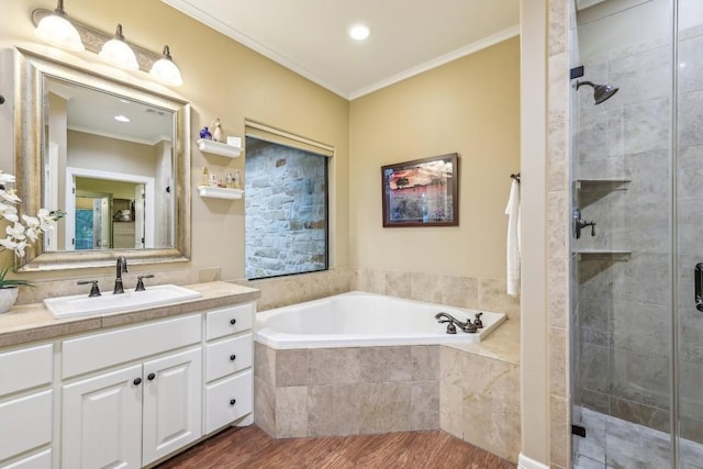 bathroom featuring crown molding, a bath, wood finished floors, and a stall shower