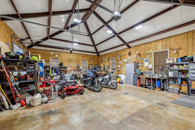 garage with a workshop area and a garage door opener