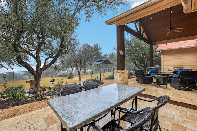 view of patio with a gazebo, outdoor lounge area, and ceiling fan