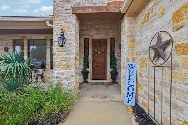 doorway to property with stone siding