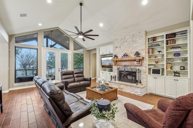 living room with a fireplace, wood finished floors, plenty of natural light, vaulted ceiling, and recessed lighting