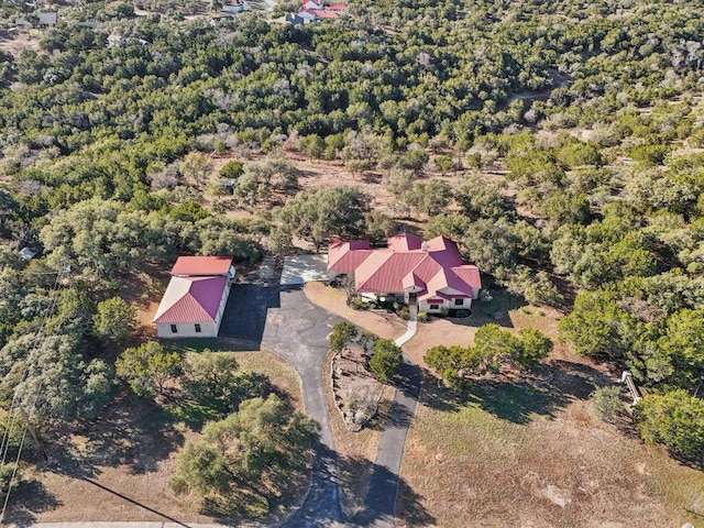 drone / aerial view featuring a forest view