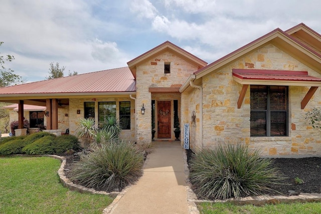 view of front facade featuring stone siding and metal roof